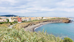 Beach with black sand from ancient volcano in Agde