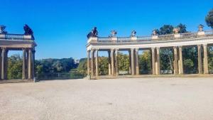 Columns at entrance to Sanssouci Palace with "fake" ruins in background. Potsdam, Germany