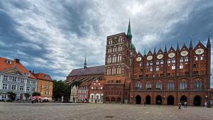 Interesting town hall with smaller buildings in front of it in Stralsund, Germany