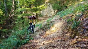Mike pushing Jackie's bike over landslide. Not fun.