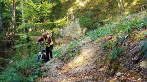 Mike gingerly navigating Jackie's bike across a mountain landslide in Maribor, Slovenia