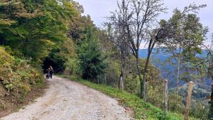 Mike pushing his bike up very steep section of mountain climb in Slovenia