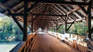 Almost 100 year old covered timber bridge over the Sava River near Litija, Slovenia